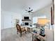 Bright living room features vaulted ceilings, a ceiling fan, wood-look floors and a decorative fireplace at 260 Killarney Bay Ct # 6-6, Winter Park, FL 32789