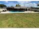 Relaxing backyard oasis with in-ground pool, awning, lounge chairs and patio at 2648 Amsden Rd, Winter Park, FL 32792