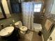 Bathroom with a vanity sink, a toilet, and a shower-tub combination behind a curtain at 2648 Amsden Rd, Winter Park, FL 32792