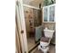 Bathroom features a tiled shower with glass doors and built-in shelves for storage at 2648 Amsden Rd, Winter Park, FL 32792