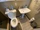 Cozy bathroom features a white pedestal sink, open-bowl toilet, and modern fixtures at 2648 Amsden Rd, Winter Park, FL 32792