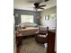 A cozy bedroom featuring a comfortable daybed, an armchair, and a ceiling fan at 2648 Amsden Rd, Winter Park, FL 32792