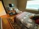 Comfortable bedroom featuring a chaise lounge and mounted TV for relaxation at 2648 Amsden Rd, Winter Park, FL 32792