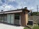 Exterior showing a brown sunroom with a white awning and double doors leading to the pool at 2648 Amsden Rd, Winter Park, FL 32792