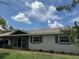 Exterior view of the single story home showcasing the neutral colors, updated windows and manicured landscaping at 2648 Amsden Rd, Winter Park, FL 32792
