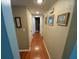 Well-lit hallway showcasing beautiful hardwood floors and framed artwork on the walls at 2648 Amsden Rd, Winter Park, FL 32792