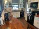 A well-lit kitchen with butcher block countertops, white cabinets, and black appliances provides functionality and style at 2648 Amsden Rd, Winter Park, FL 32792