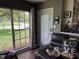 The living room provides access to the exterior and features a large window and comfortable seating at 2648 Amsden Rd, Winter Park, FL 32792