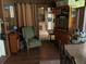Cozy living room featuring a comfortable green armchair and dark wood paneling at 2648 Amsden Rd, Winter Park, FL 32792