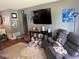 The cozy living room features neutral colors, a large TV, and comfortable furnishings at 2648 Amsden Rd, Winter Park, FL 32792