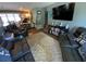 Cozy living room featuring recliners, a floral rug, and a large television for a relaxed and inviting atmosphere at 2648 Amsden Rd, Winter Park, FL 32792