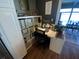 Bright office space includes custom shelves, a large desk, and backyard views, perfect for working from home at 2648 Amsden Rd, Winter Park, FL 32792