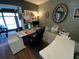 A well-organized home office with custom desk, decorative mirror and natural light offers a comfortable workspace at 2648 Amsden Rd, Winter Park, FL 32792