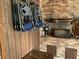 Outdoor kitchen featuring a brick backsplash, a grill, and hanging blue folding chairs at 2648 Amsden Rd, Winter Park, FL 32792