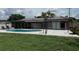 An inviting swimming pool, patio, and grassy area enhance the backyard of this charming home at 2648 Amsden Rd, Winter Park, FL 32792