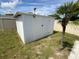 View of exterior shed on lot, along with privacy fence and small palm tree at 2648 Amsden Rd, Winter Park, FL 32792