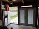View of storage area with an outdoor exit and a refrigerator at 2648 Amsden Rd, Winter Park, FL 32792