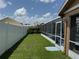 Backyard featuring a vinyl fence and screened-in patio at 2693 Maxwell W Ct, Kissimmee, FL 34743