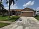 Charming single-story home with well-manicured lawn and mature palm tree at 2693 Maxwell W Ct, Kissimmee, FL 34743