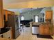 Kitchen features wooden cabinets, tile backsplash and stainless steel appliances at 2693 Maxwell W Ct, Kissimmee, FL 34743