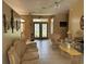 Spacious living room with tile flooring, ornate decor, and large windows at 2693 Maxwell W Ct, Kissimmee, FL 34743