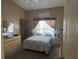 Inviting bedroom featuring neutral colors, soft carpet, window, and furniture at 2693 Maxwell W Ct, Kissimmee, FL 34743