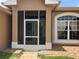 Home screened entry with decorative glass doors and sidelight windows at 2693 Maxwell W Ct, Kissimmee, FL 34743