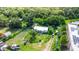 Aerial view of the property, showcasing the home's layout, surrounding greenery, and nearby road at 2915 Dean Ridge Rd, Orlando, FL 32825