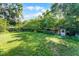 Spacious backyard with healthy green grass, mature trees, and plenty of space to play at 2915 Dean Ridge Rd, Orlando, FL 32825