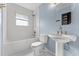 Bathroom features a white bathtub, toilet, white subway tile surround, and pedestal sink at 2915 Dean Ridge Rd, Orlando, FL 32825