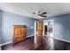 Bedroom with dark wood floors, mirrored closet doors, and ceiling fan at 2915 Dean Ridge Rd, Orlando, FL 32825