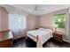Cozy bedroom featuring natural light from window, ceiling fan, and dark wood flooring at 2915 Dean Ridge Rd, Orlando, FL 32825