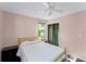Bedroom featuring a window, dark wood floors, ceiling fan, and ample space at 2915 Dean Ridge Rd, Orlando, FL 32825