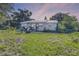 Charming single-story home featuring a metal roof and set on a spacious lot surrounded by mature trees at 2915 Dean Ridge Rd, Orlando, FL 32825