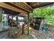 Exterior view under a covered structure with yard debris around the support beams, with a storage area at 2915 Dean Ridge Rd, Orlando, FL 32825
