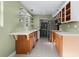 Bright kitchen featuring quartz countertops, floating shelves, stainless steel appliances, and patterned tile flooring at 2915 Dean Ridge Rd, Orlando, FL 32825