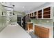 Well-lit kitchen with stainless steel appliances, quartz countertops, floating shelves, and patterned tile flooring at 2915 Dean Ridge Rd, Orlando, FL 32825