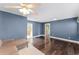 Open living room with modern lighting, hardwood floors, and views into adjacent rooms enhancing spaciousness at 2915 Dean Ridge Rd, Orlando, FL 32825