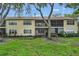 Townhouse backyard with mature trees, a grassy lawn and screened patios at 3030 Clubview Dr # Ge, Orlando, FL 32822