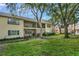 Townhouse backyard and patio with mature trees, a grassy lawn and screened patios at 3030 Clubview Dr # Ge, Orlando, FL 32822