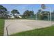 Outdoor basketball court with well-defined lines and hoops, surrounded by green grass and trees at 3030 Clubview Dr # Ge, Orlando, FL 32822