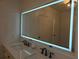 Modern bathroom with a double sink vanity and illuminated mirror at 3030 Clubview Dr # Ge, Orlando, FL 32822