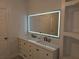 Stylish bathroom featuring a double vanity and a sleek, modern mirror at 3030 Clubview Dr # Ge, Orlando, FL 32822