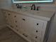 Close-up of a double vanity featuring white countertop and dark hardware at 3030 Clubview Dr # Ge, Orlando, FL 32822
