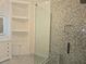 Elegant bathroom with spacious glass shower and custom shelving unit at 3030 Clubview Dr # Ge, Orlando, FL 32822