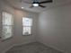 Bright bedroom with neutral walls, ceiling fan, tile floors, and natural light streaming through the windows at 3030 Clubview Dr # Ge, Orlando, FL 32822