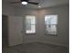 Sunlit bedroom featuring tile floors, a ceiling fan, and a white door that complements the bright interior at 3030 Clubview Dr # Ge, Orlando, FL 32822