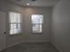 Well-lit bedroom with tile floors, crisp white walls and trim, and natural light from two windows at 3030 Clubview Dr # Ge, Orlando, FL 32822