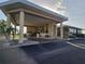 Grand entrance to the clubhouse featuring a covered portico, manicured landscaping, and a welcoming design at 3030 Clubview Dr # Ge, Orlando, FL 32822