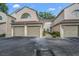Exterior of a townhouse shows attached garages and well maintained landscaping at 3030 Clubview Dr # Ge, Orlando, FL 32822